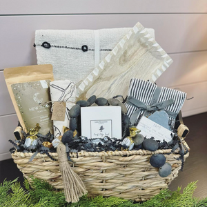 Modern Cottage Co Gift Basket Display with several products and home decor items in a wicker basket.